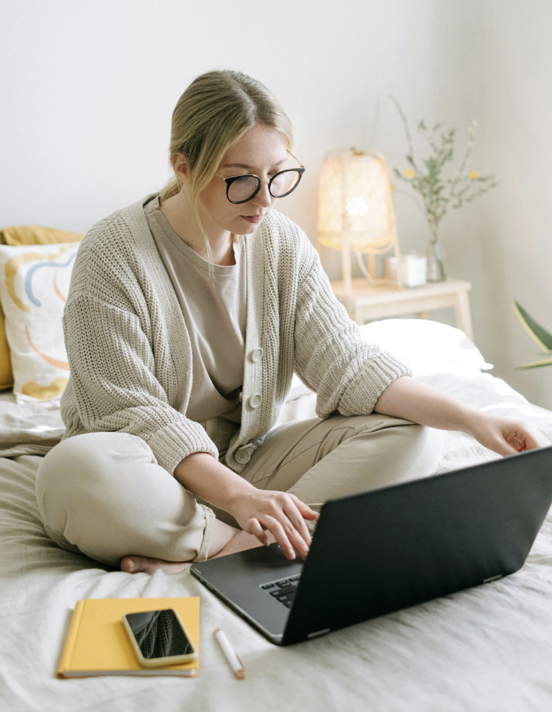 Woman typing on on laptop using ChatGPT for relationship advice and help.